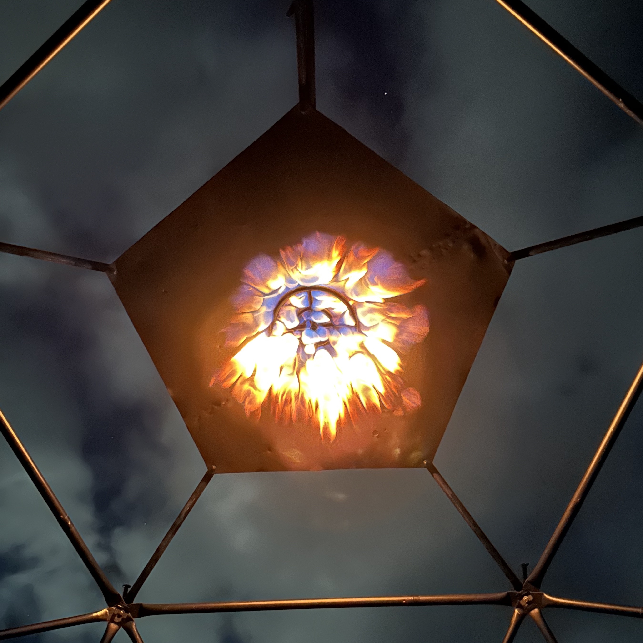 AGNIS geodesic dome lit by fire at night